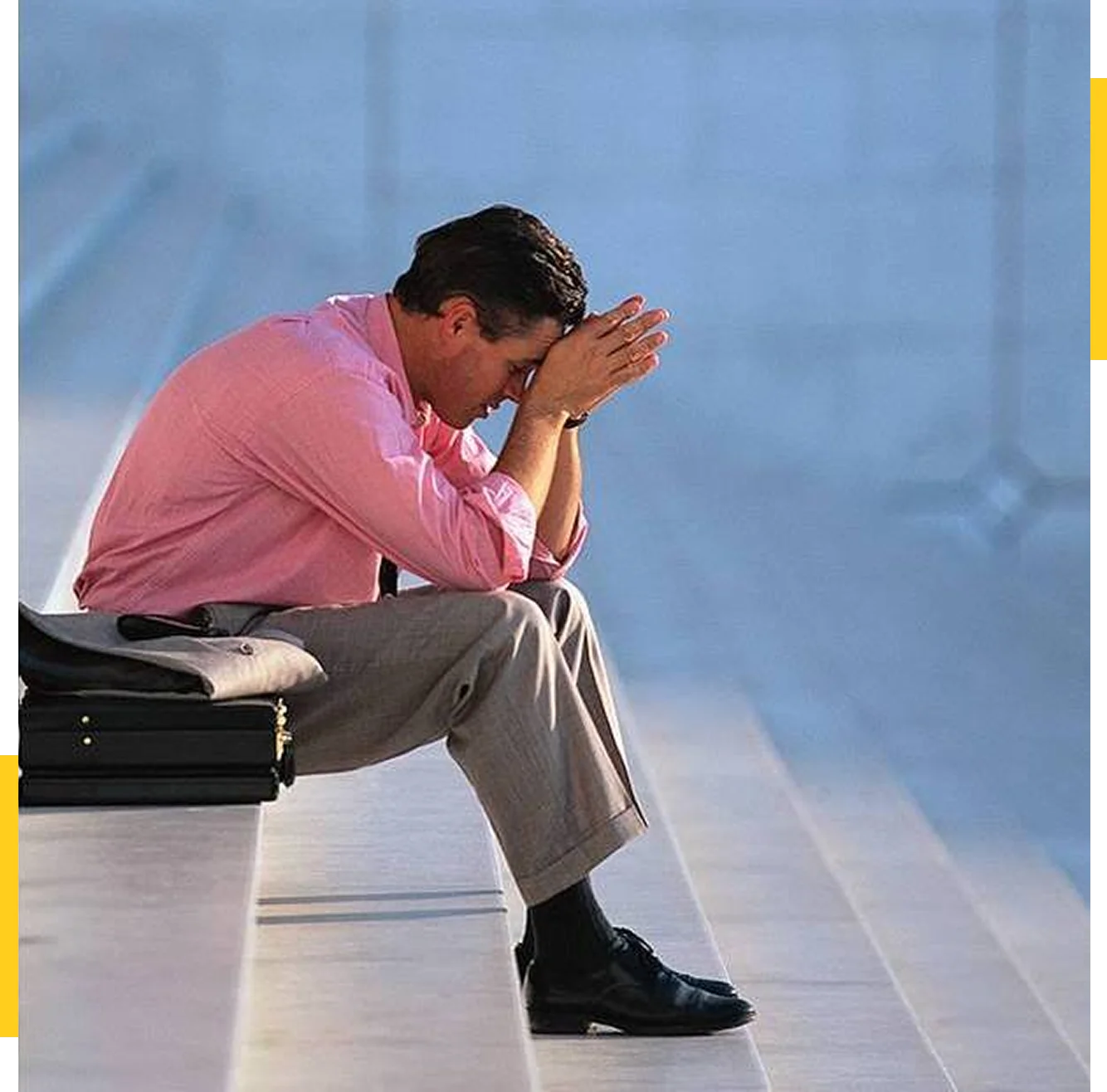 Man sitting on steps with briefcase