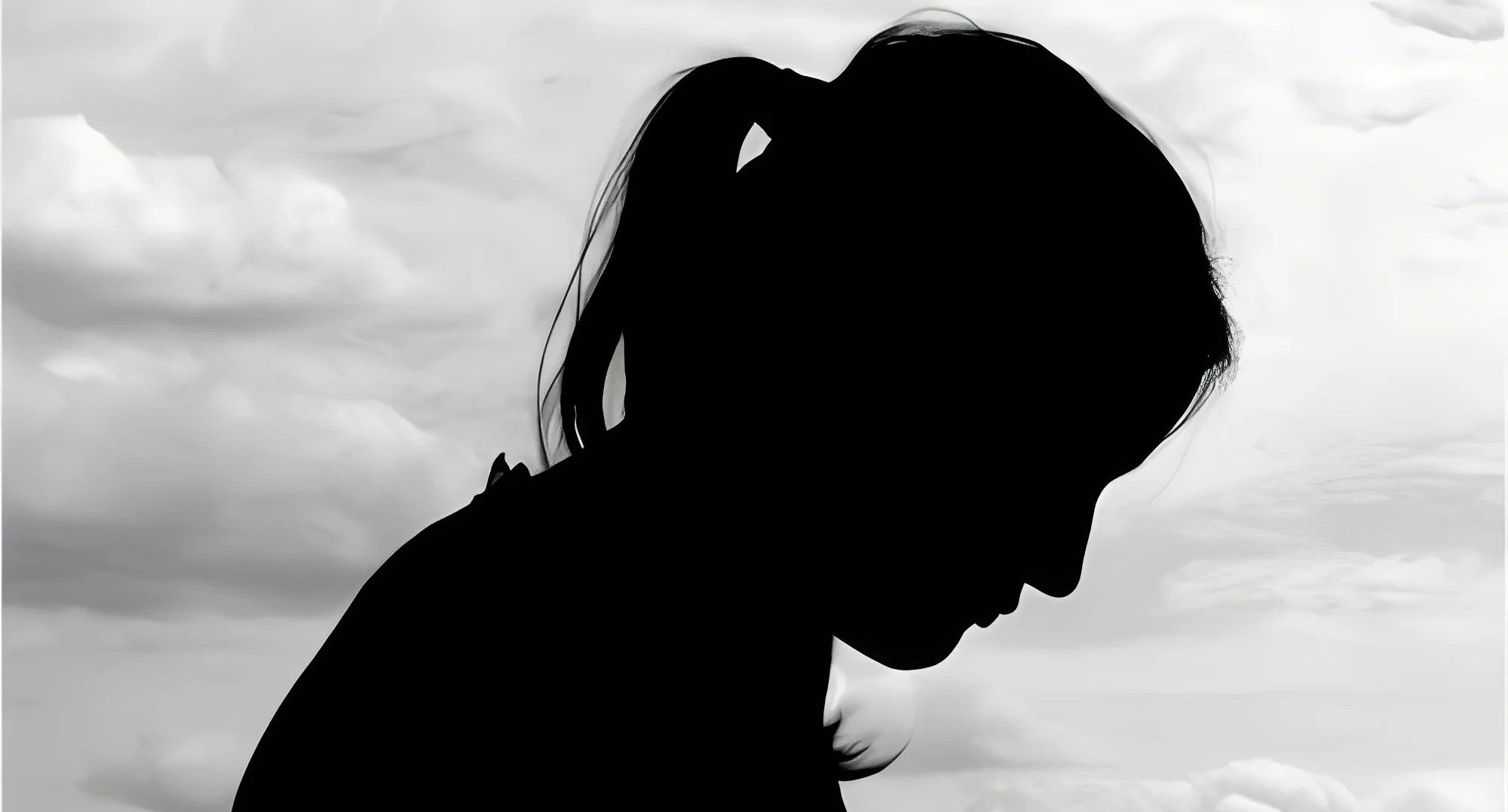 Profile silhouette of woman outdoors