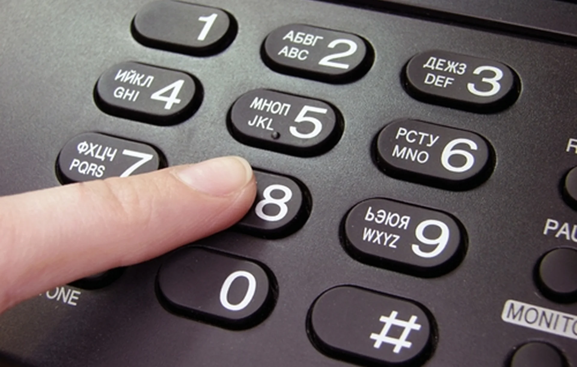 Close-up of finger on phone keys.